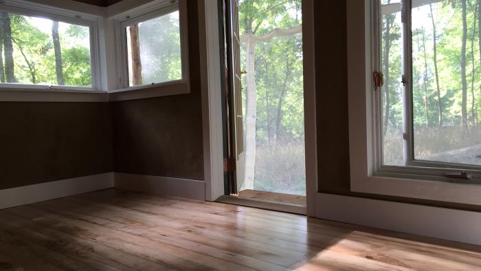 The finished cabin interior, including all naturally finished maple wood floors and clay-plastered walls